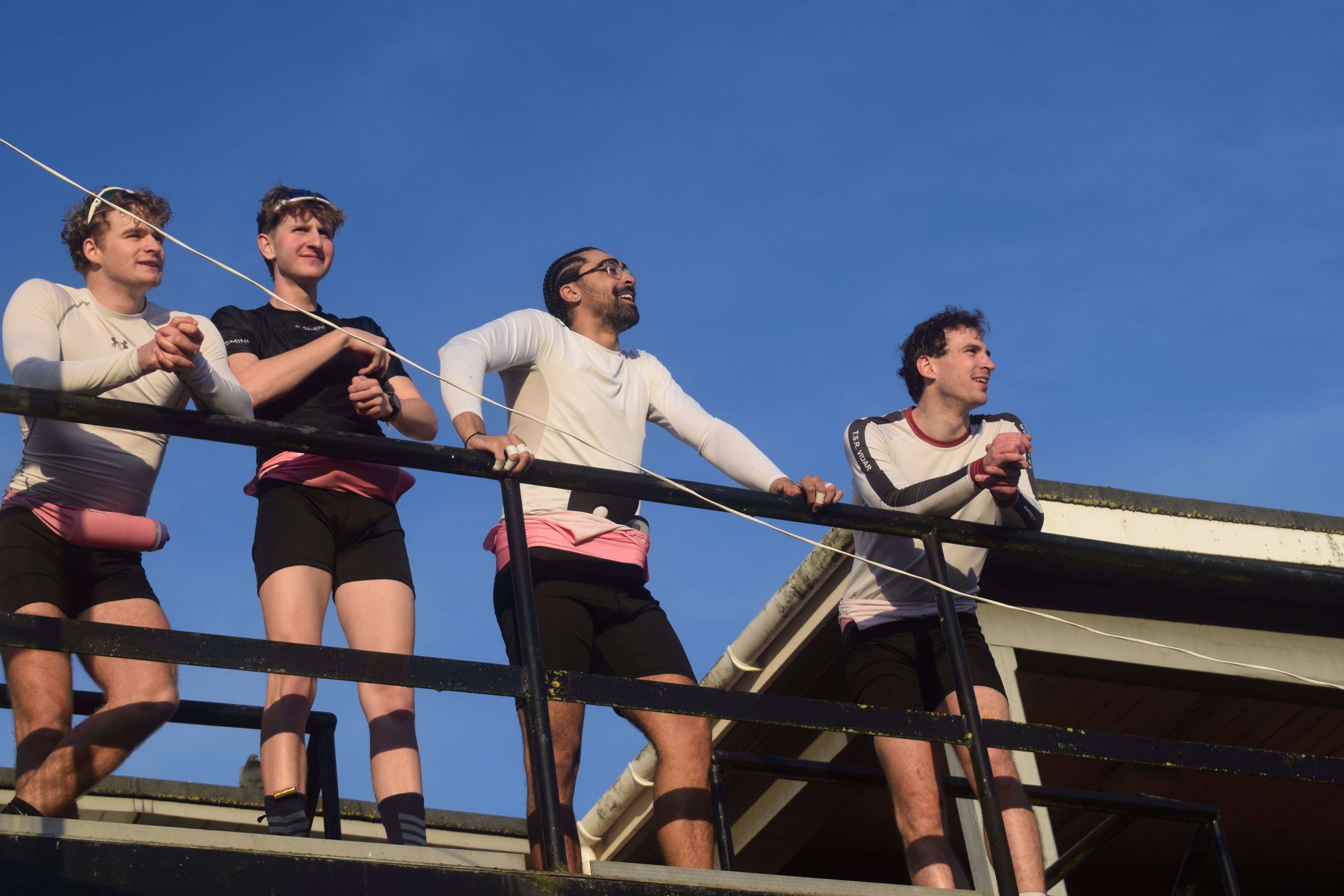 Four M1 rowers on the Boathouse balcony.