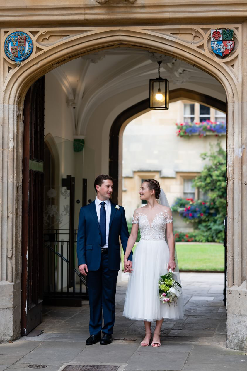 Sam and Daniela on their wedding day outside the Porter's Lodge.