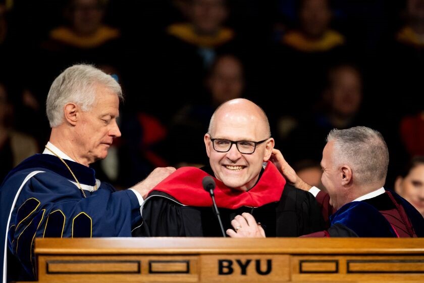 Andrew Teal receiving honorary degree from Brigham Young University President Kevin J Worthen and academic vice president C. Shane Reese 