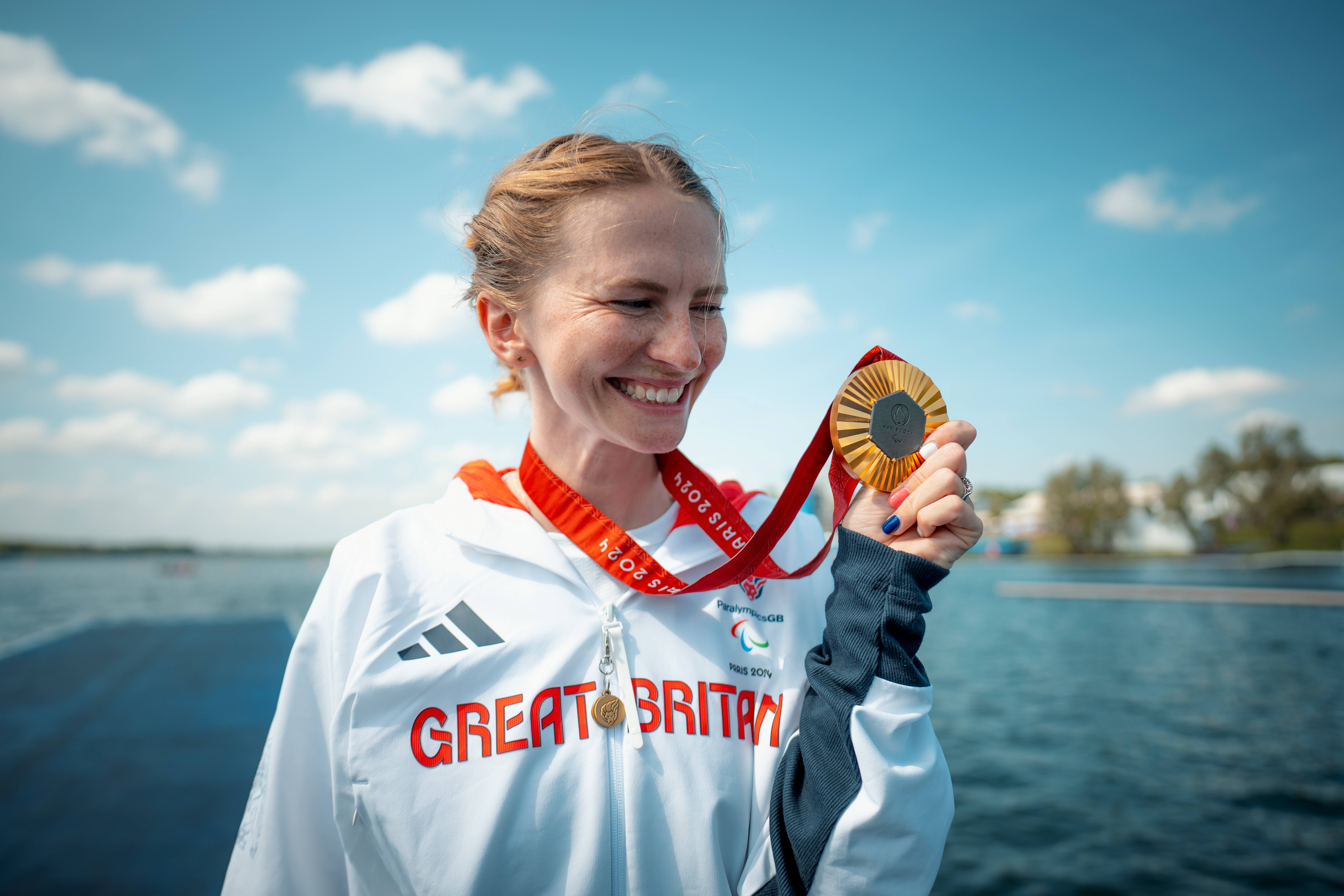 Erin Kennedy smiling and holding gold medal