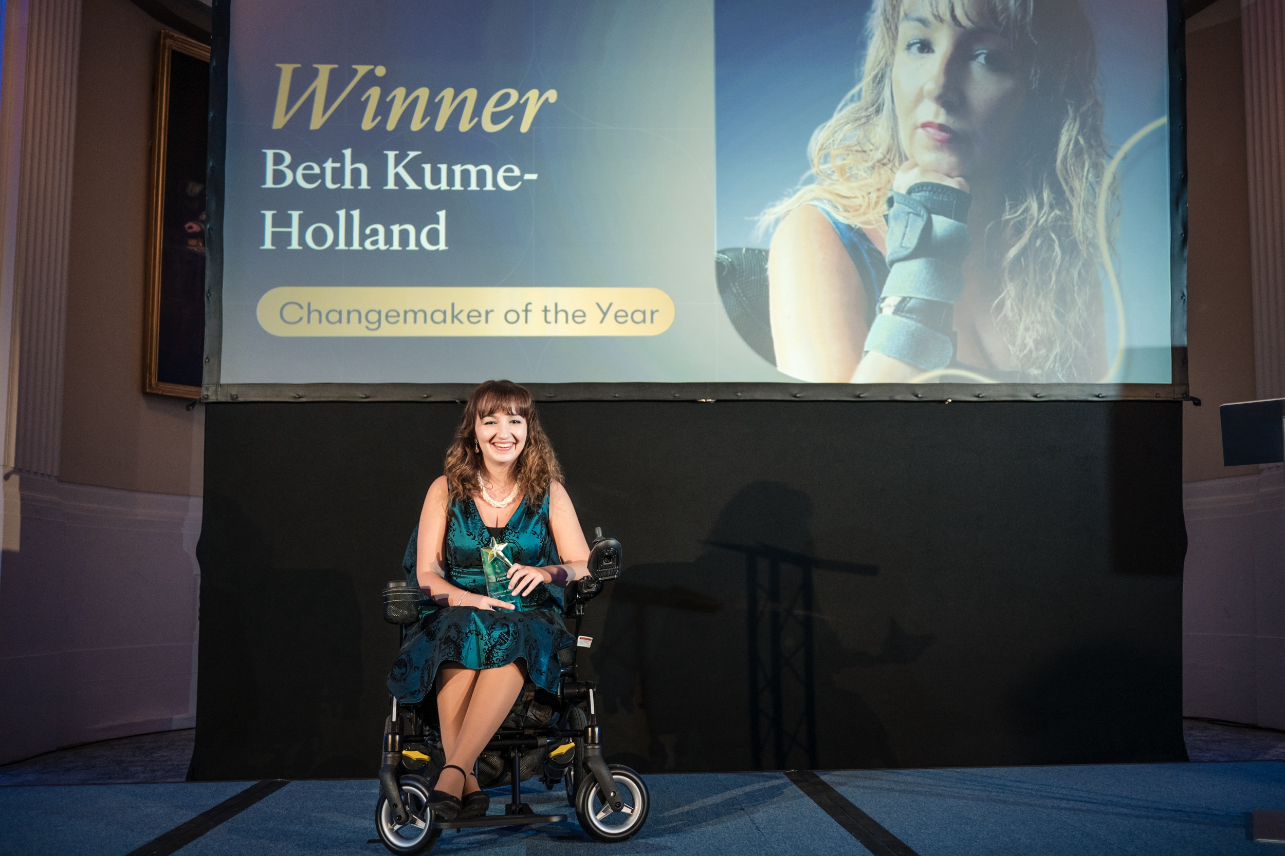 Beth-Kume Holland holding her award. 