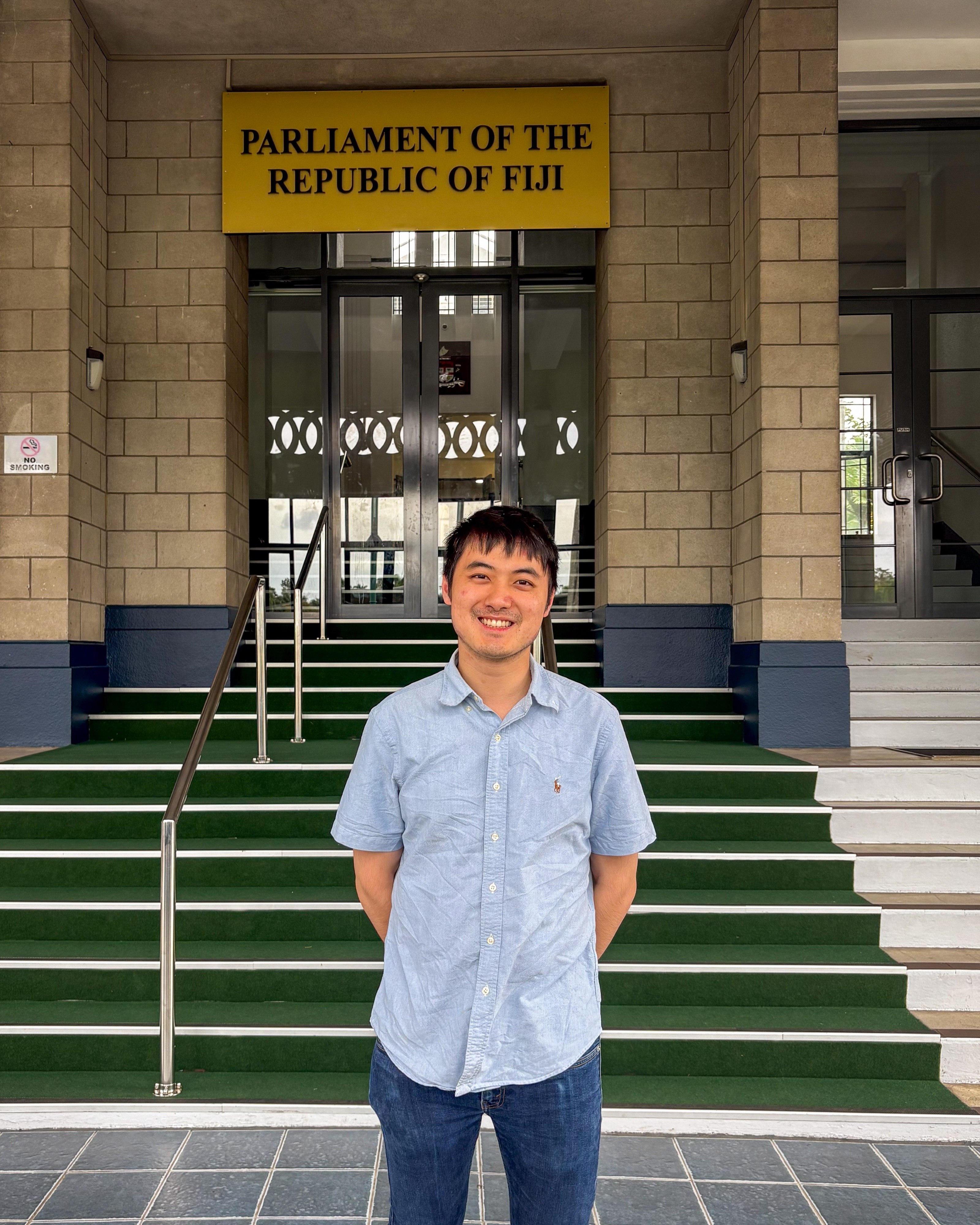 Dane Luo in front of the Parliament of the Republic of Fiji