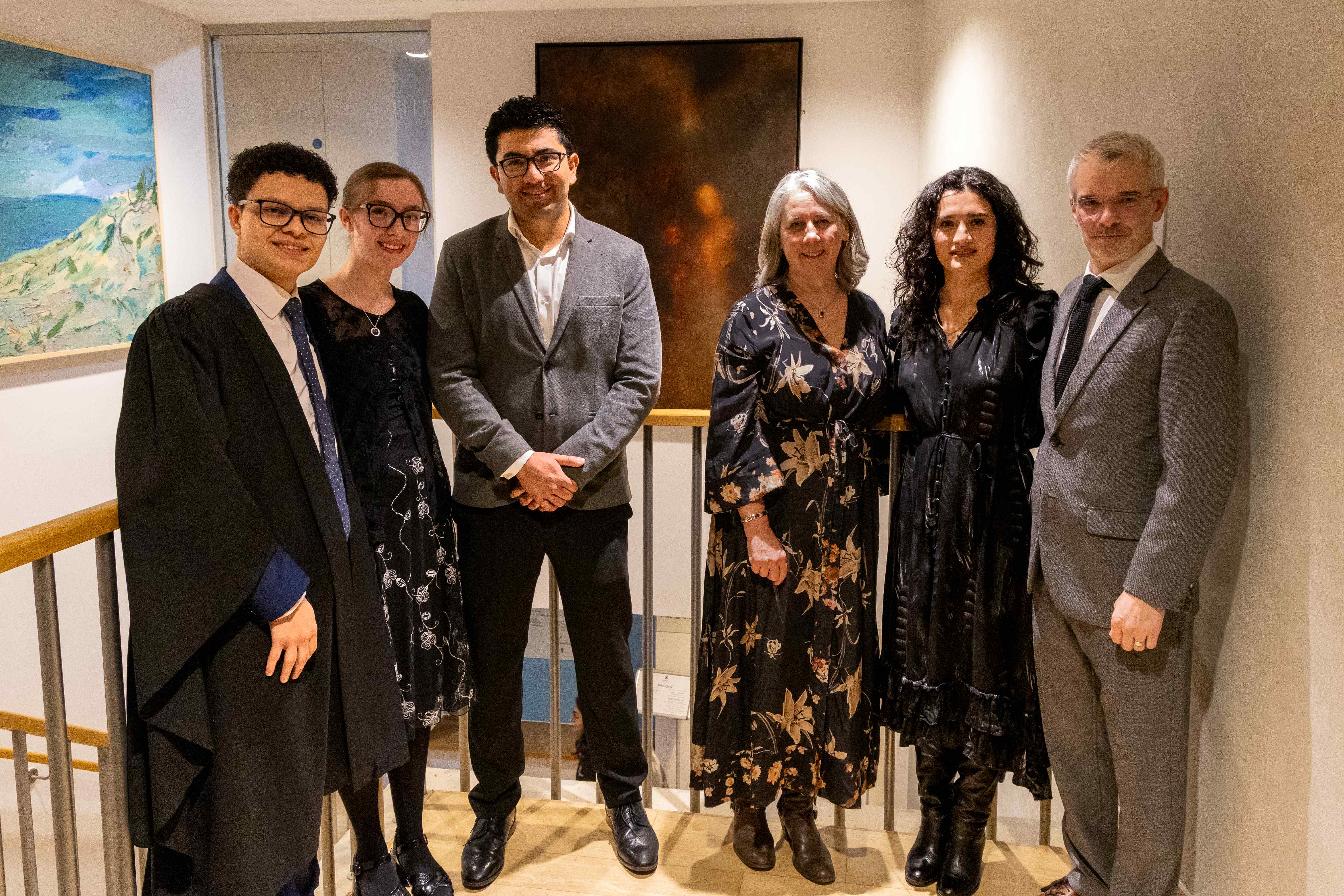 Pembroke JCR students, Miguel Moctezuma, Vanessa Gouws, Chantal Meza, and Brad Evans standing in front of Meza's Dreams of Disappearance.