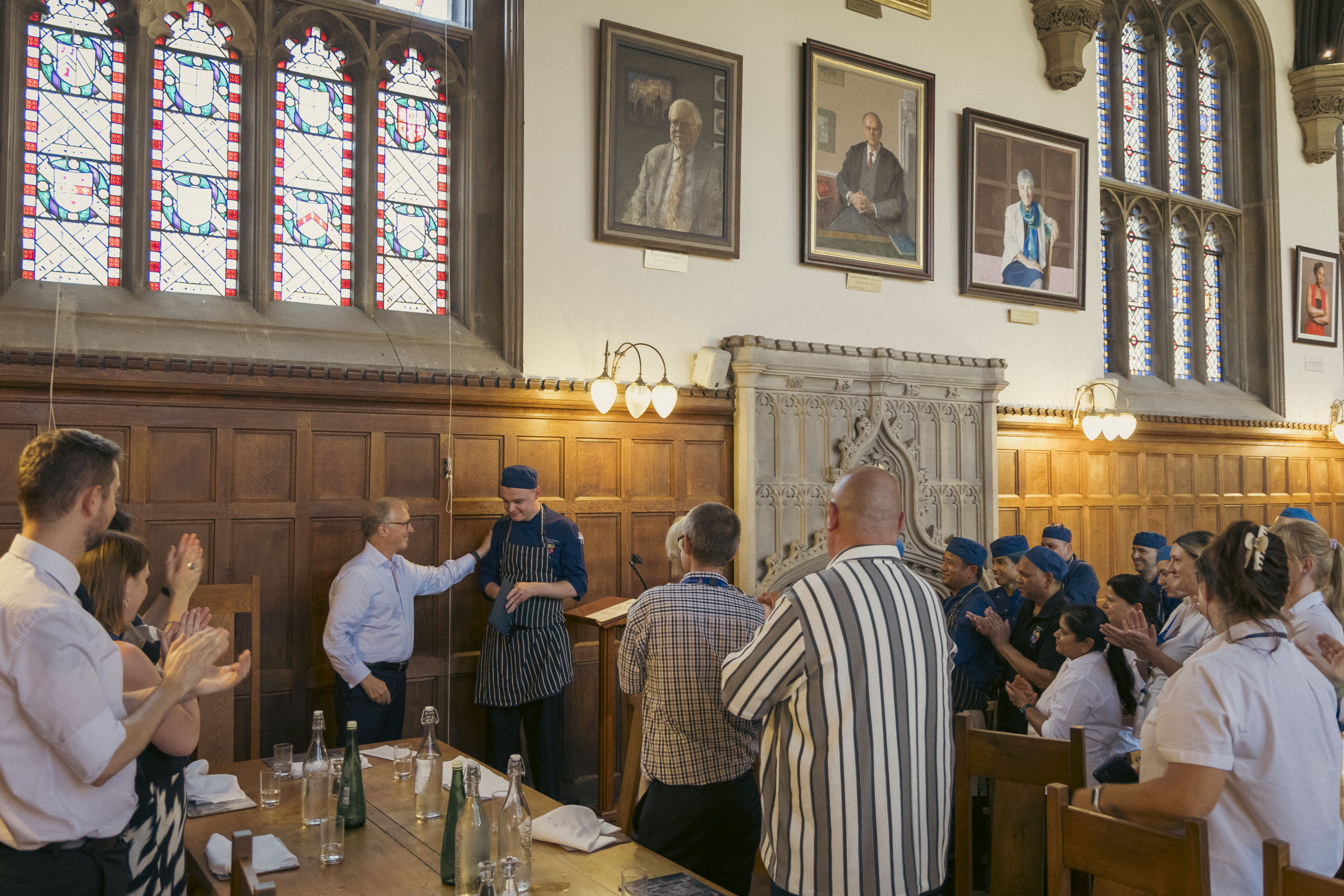 Luke receiving applause from his colleagues and the Master