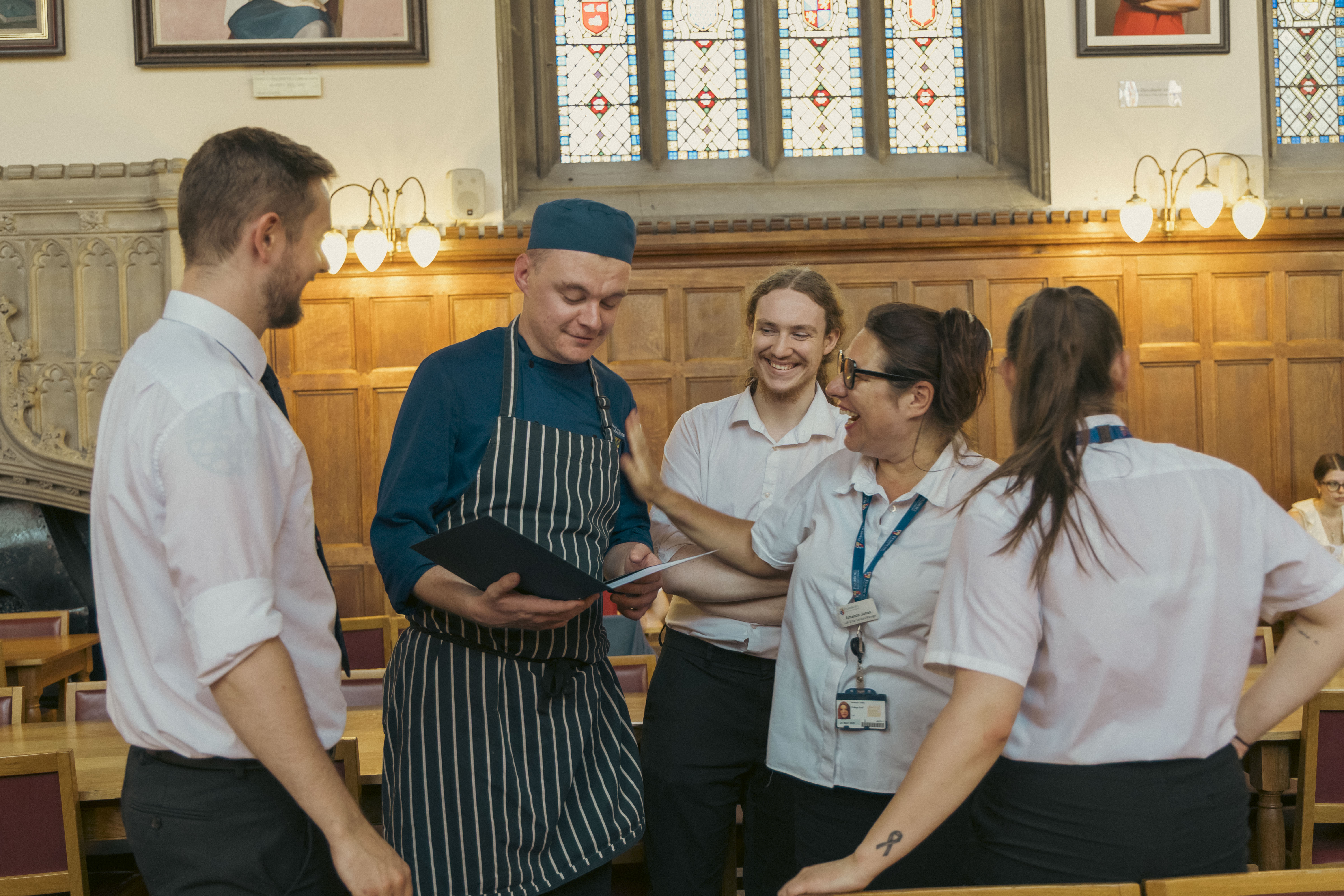 Luke showing his certificate to his colleagues.