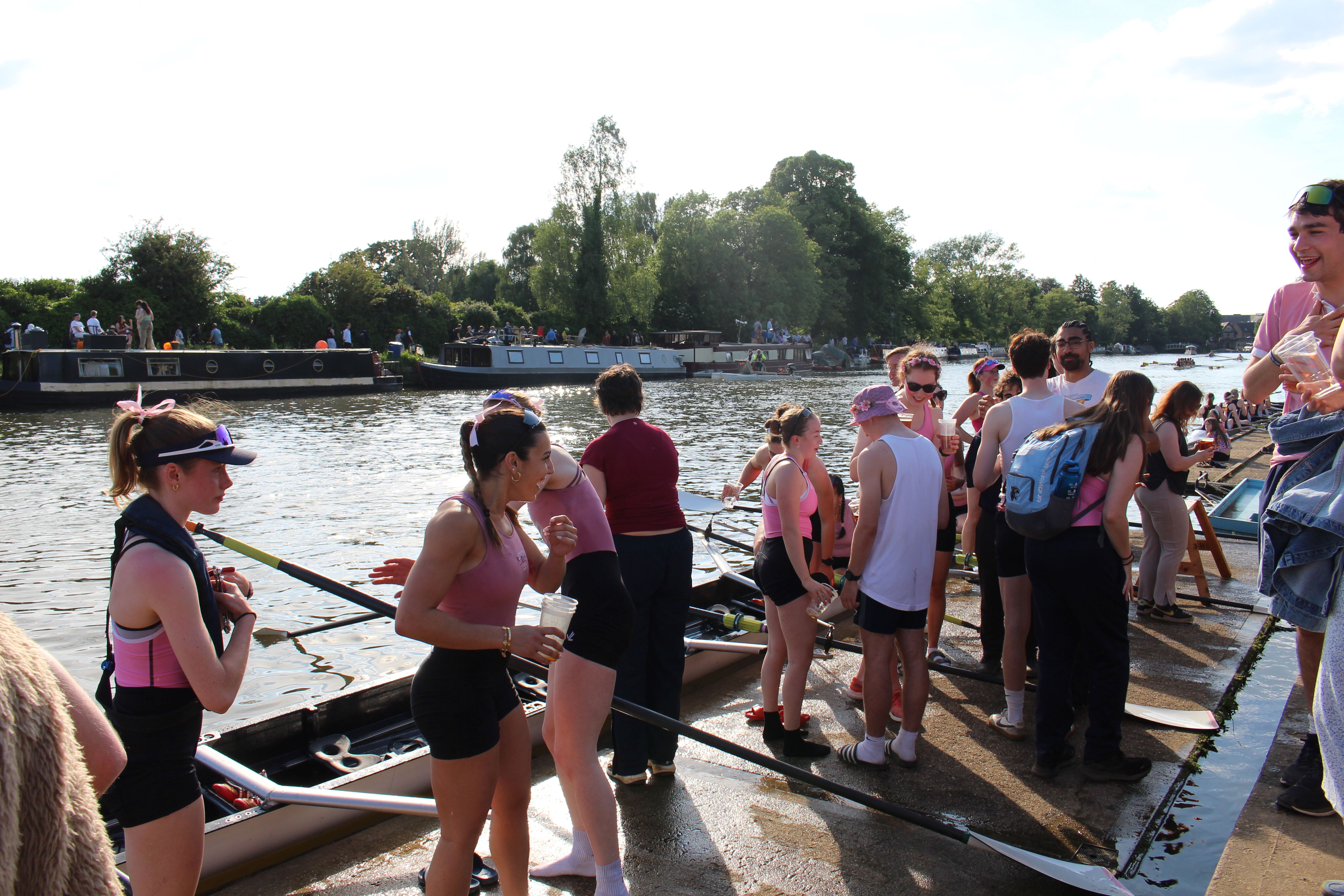 The first women's crew celebrating on the river bank after their bump on Saturday.
