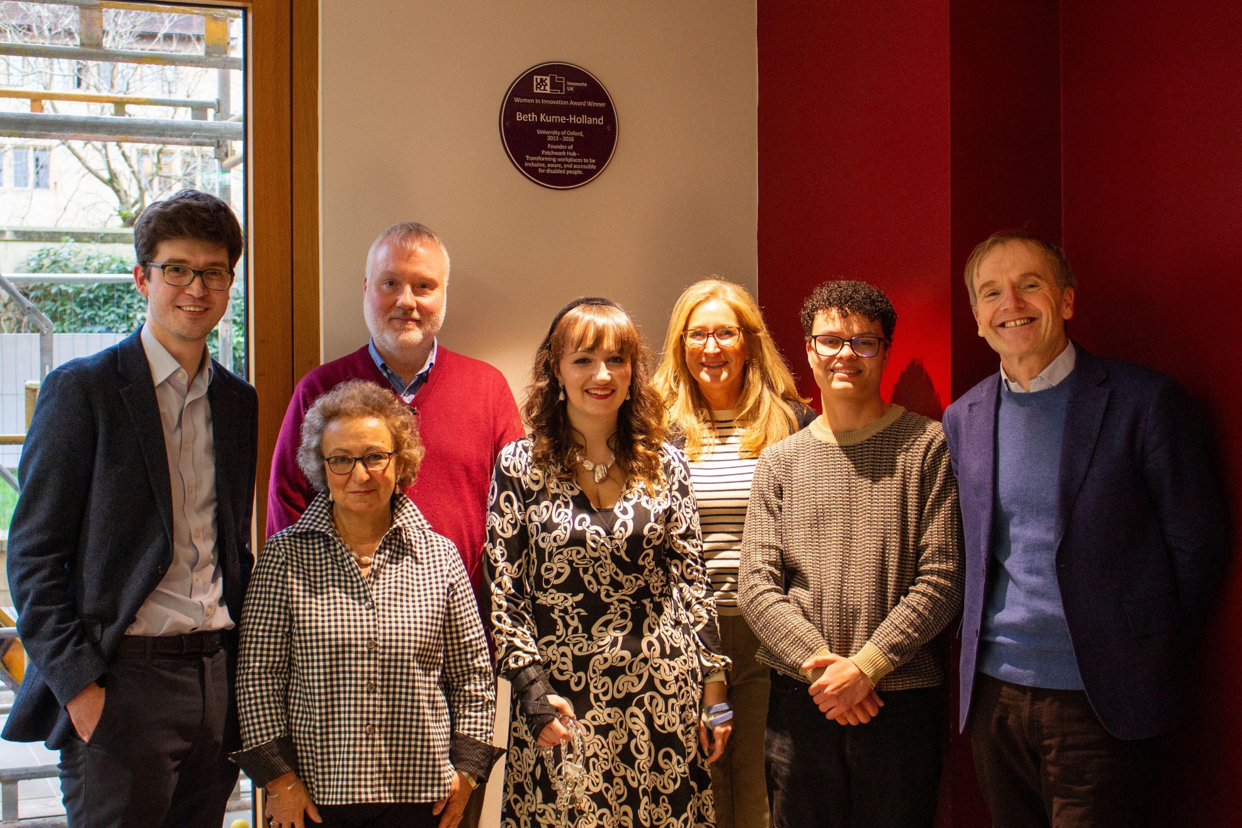 Beth surrounded by her parents, partner, a Pembroke student, and her old tutor in front of the plaque
