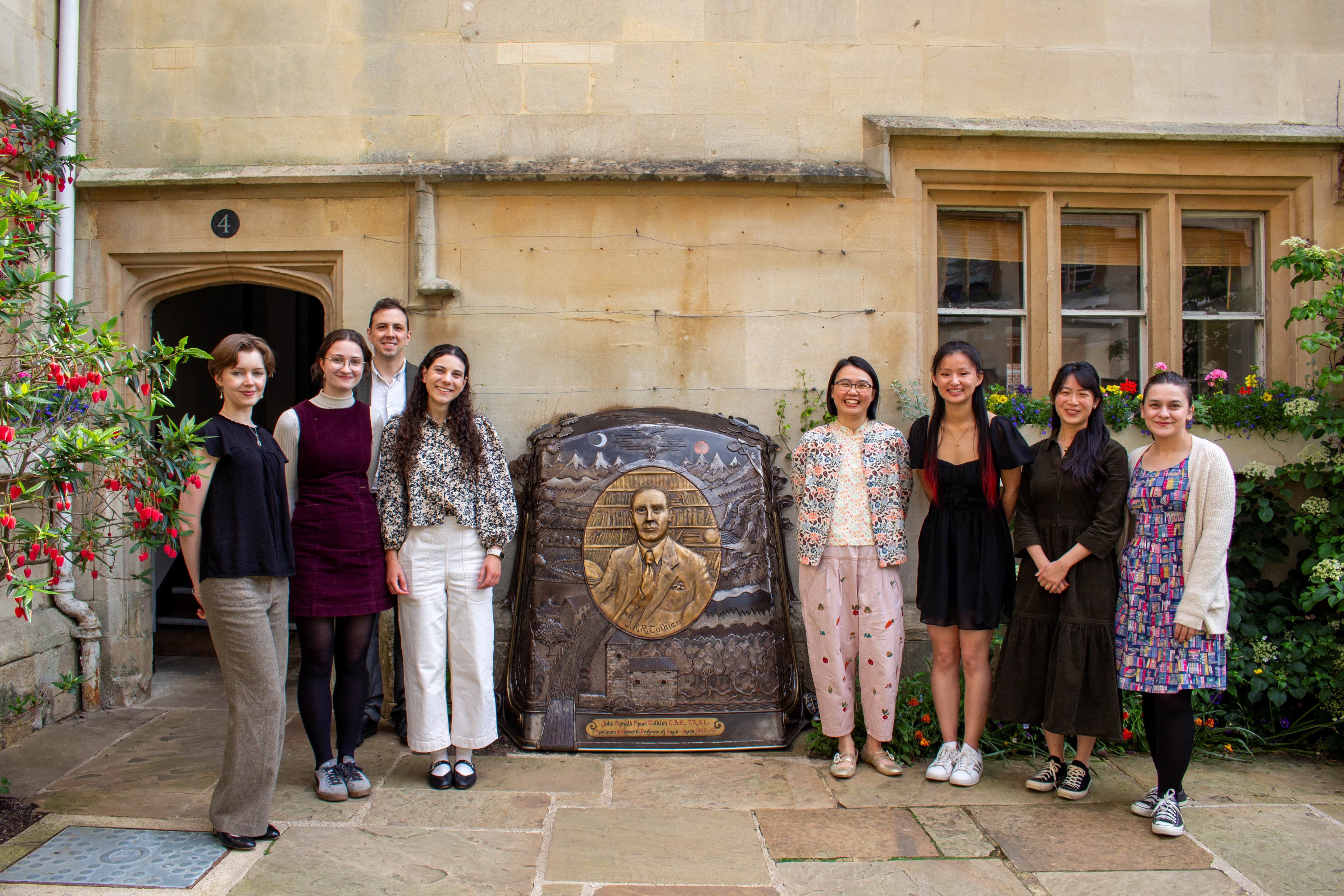 The 2025 Tolkien Lecture committee standing by the Tolkien memorial at Pembroke College, Oxford
