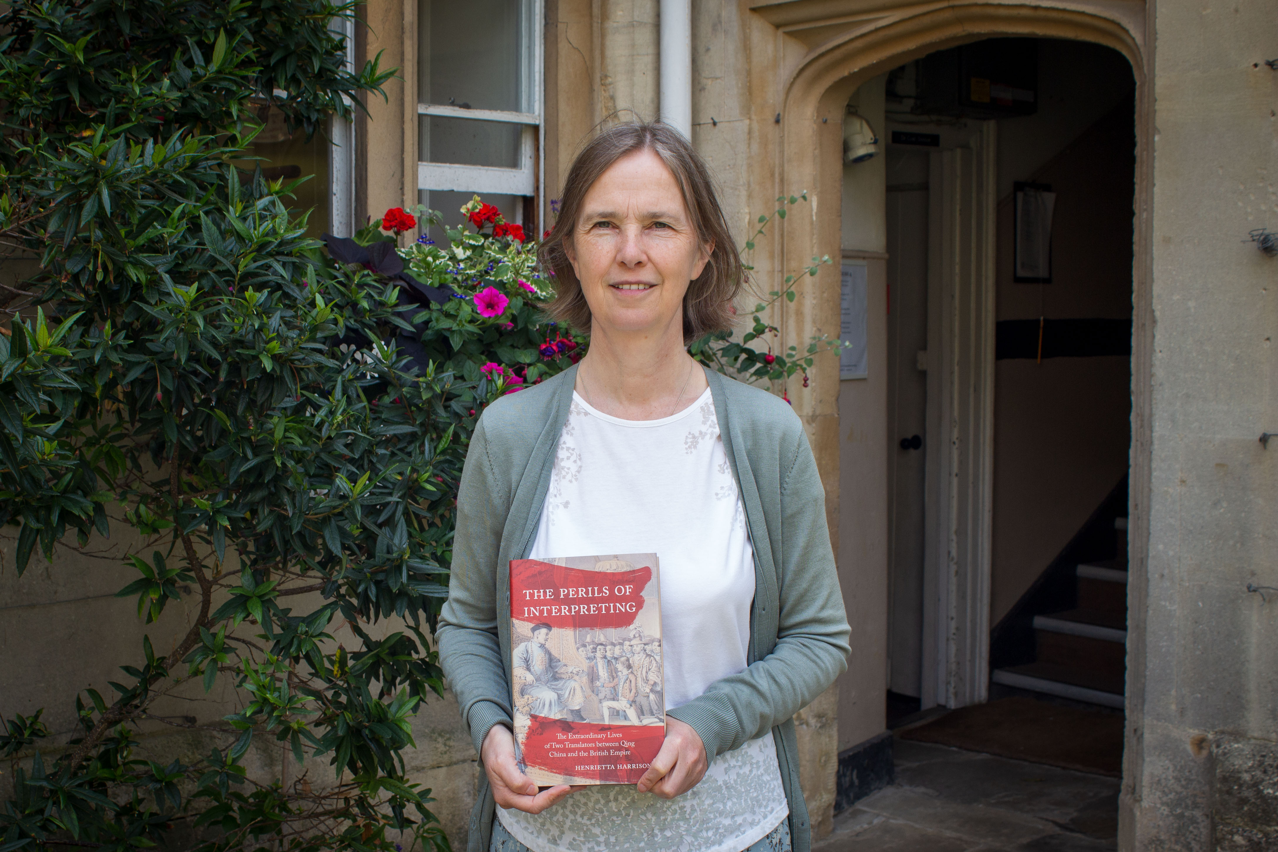 Henrietta Harrison holding copy of 'The Perils of Interpreting'