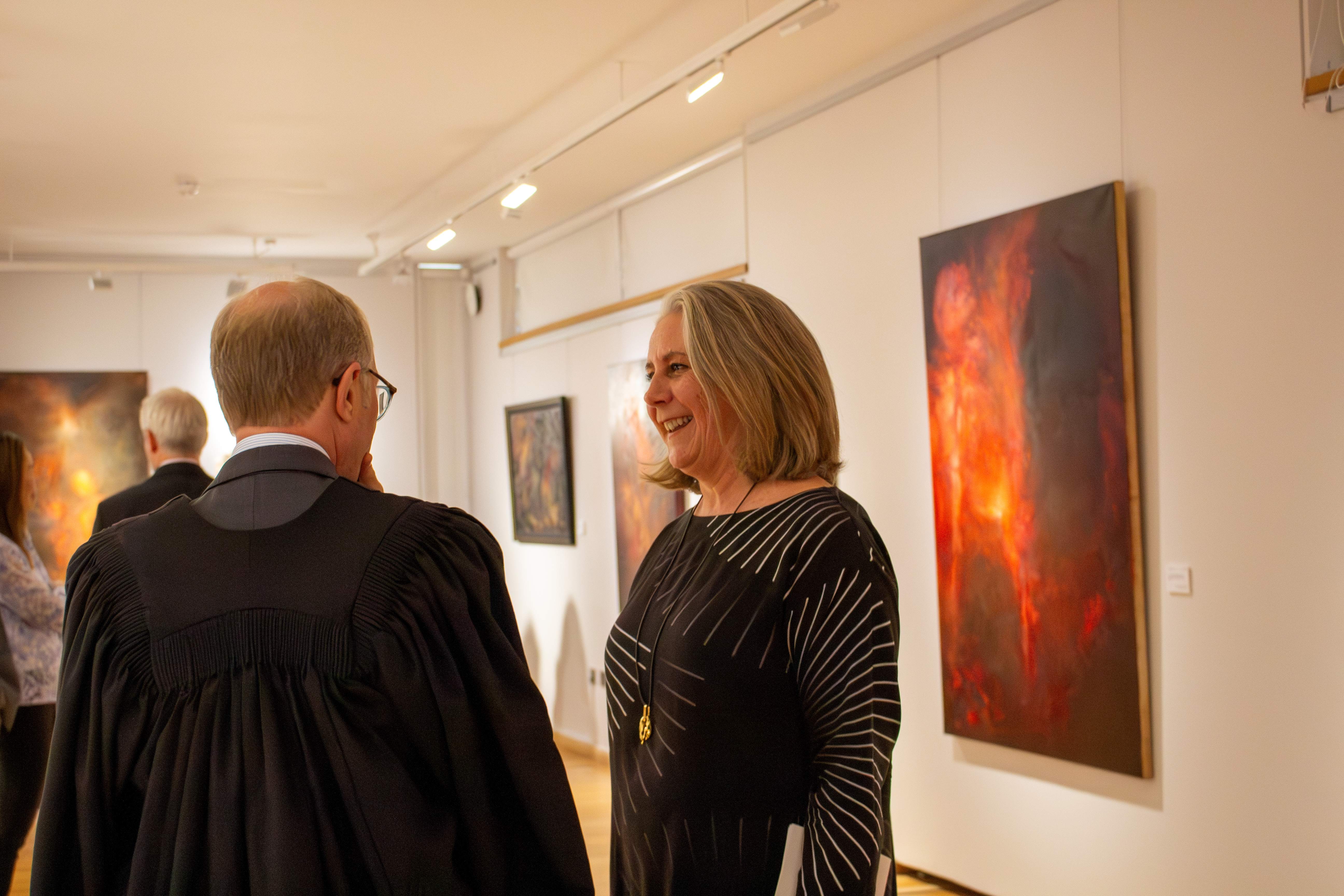 Vanessa Gouws speaking to Pembroke's Master Sir Ernest Ryder at the Disappearance of Worlds exhibition.