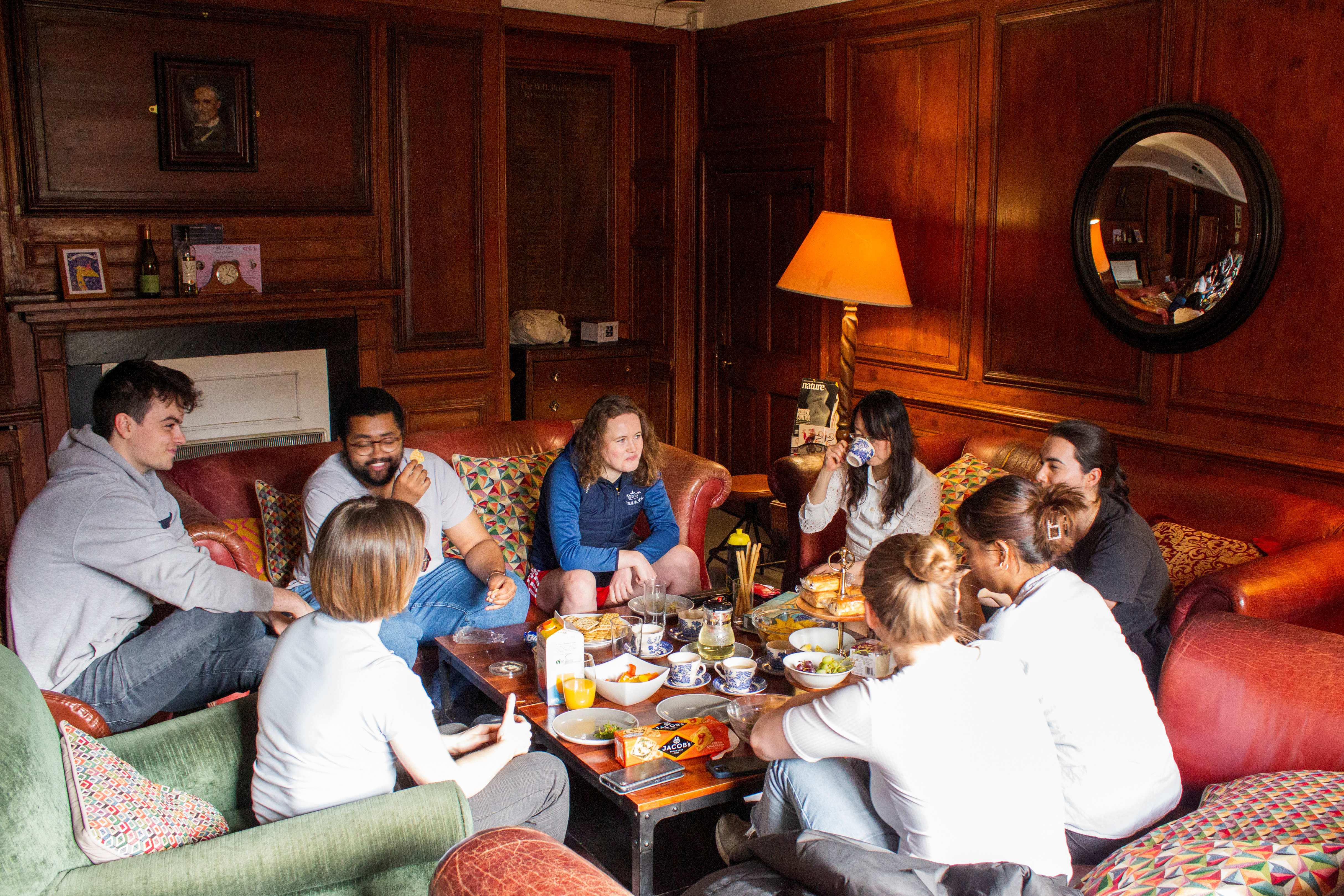 A group of Pembroke MCR students enjoying welfare tea in their common room.