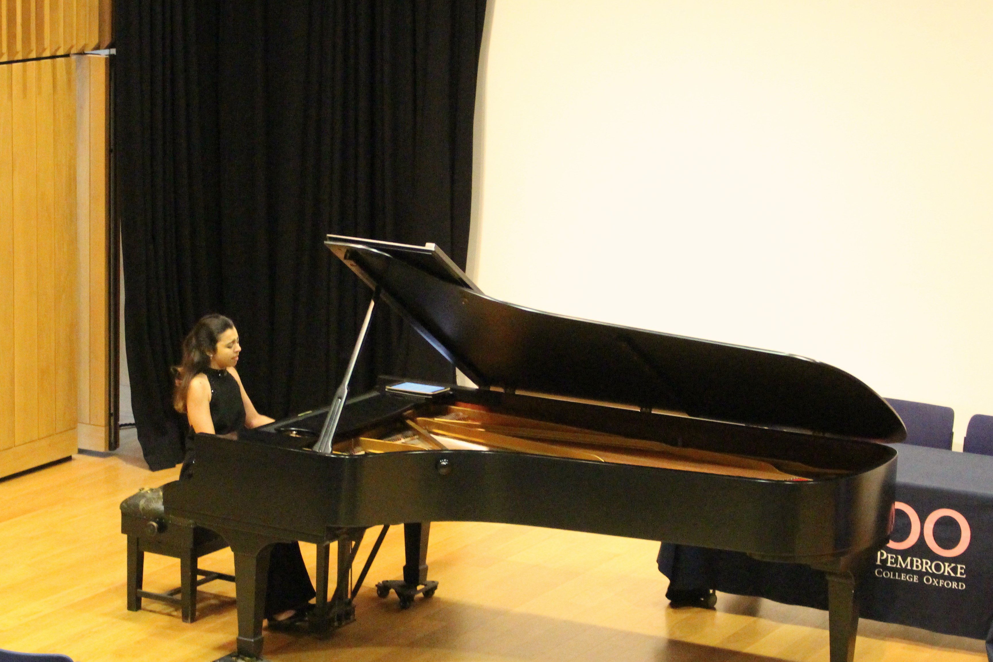 Aida Lahlou playing the piano in the Pichette Auditorium