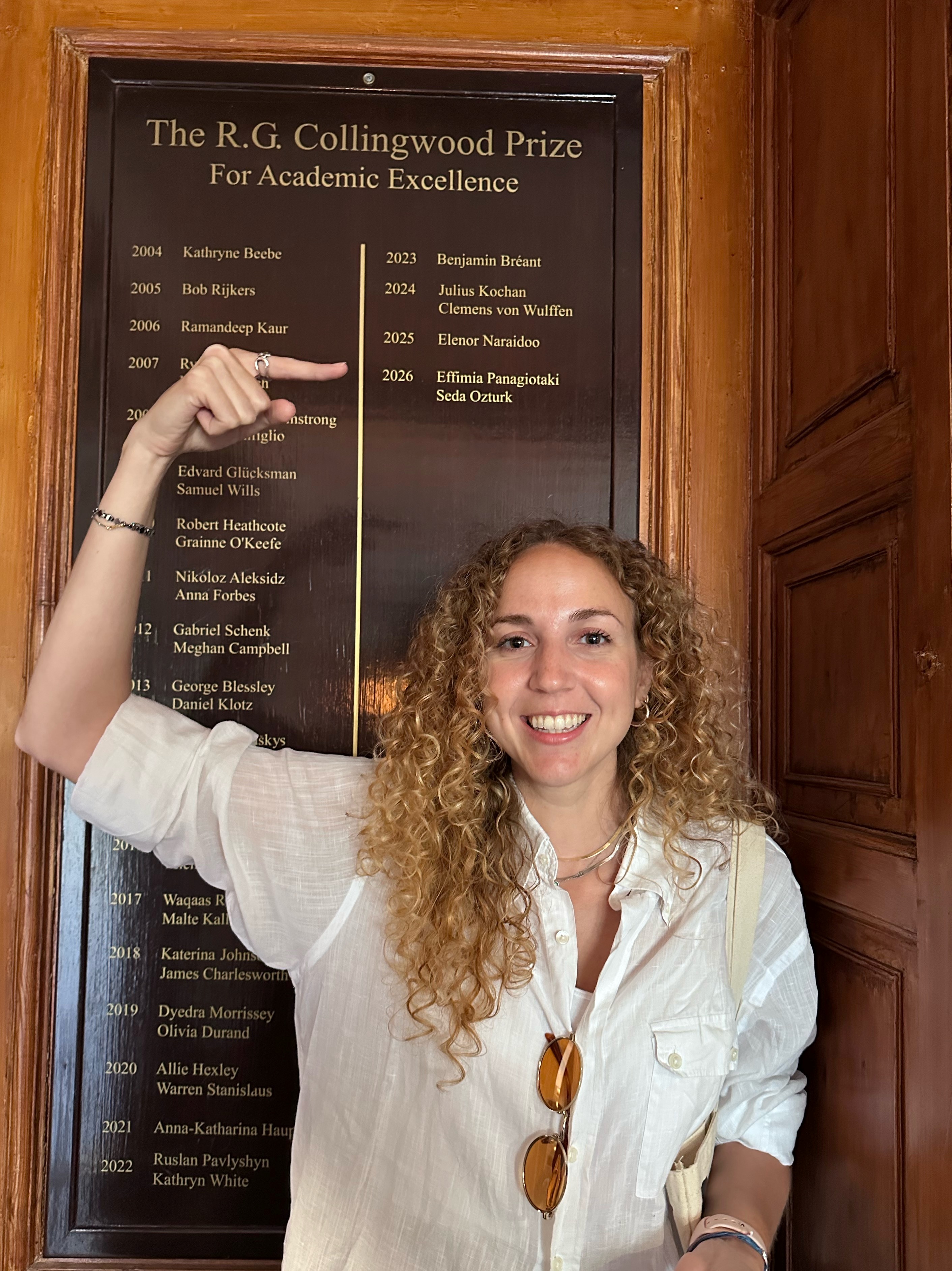 Effimia Panagiotaki in front of the Collingwood Prize board