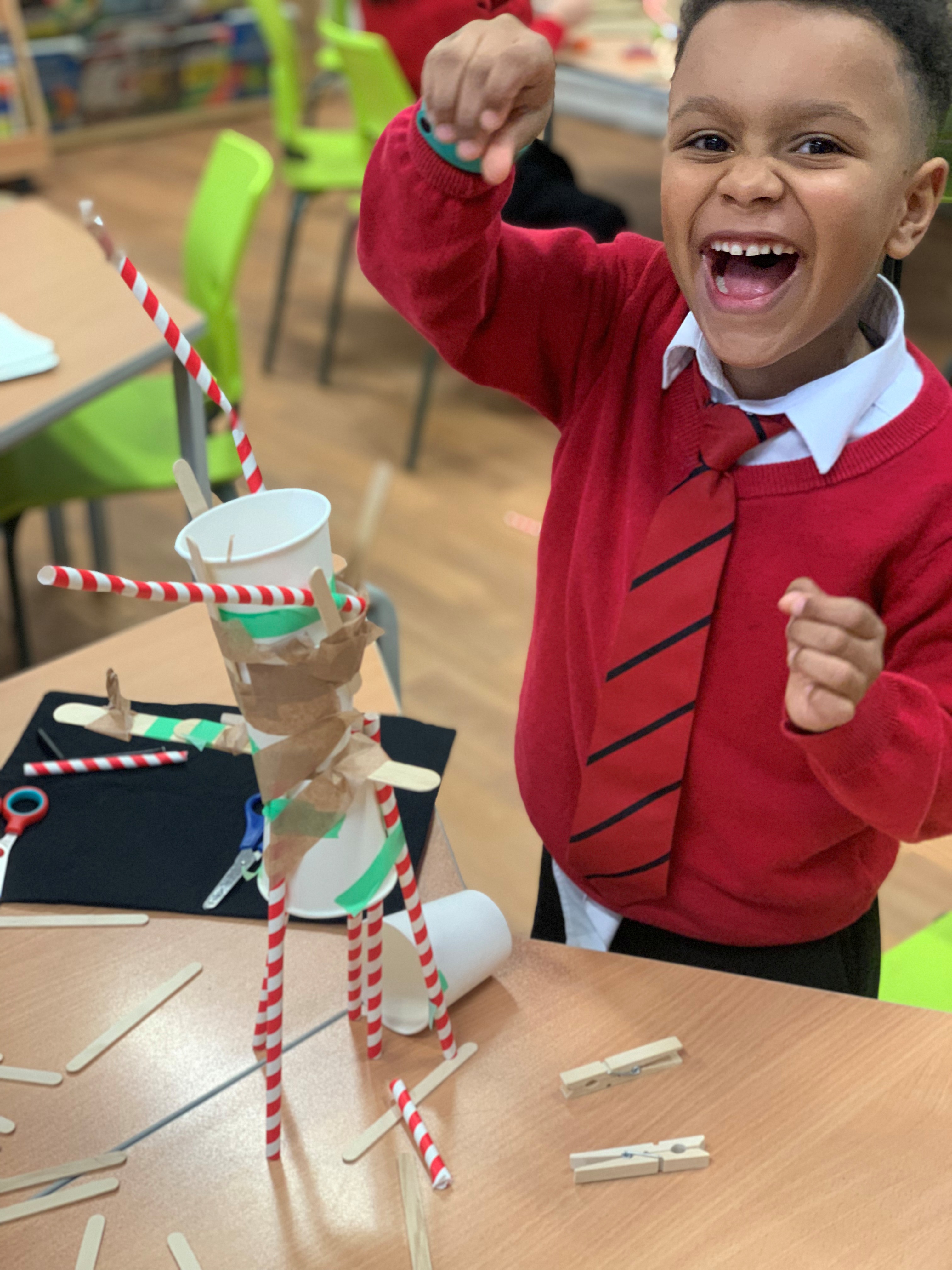 A child smiling at an Inventors and Makers workshop.