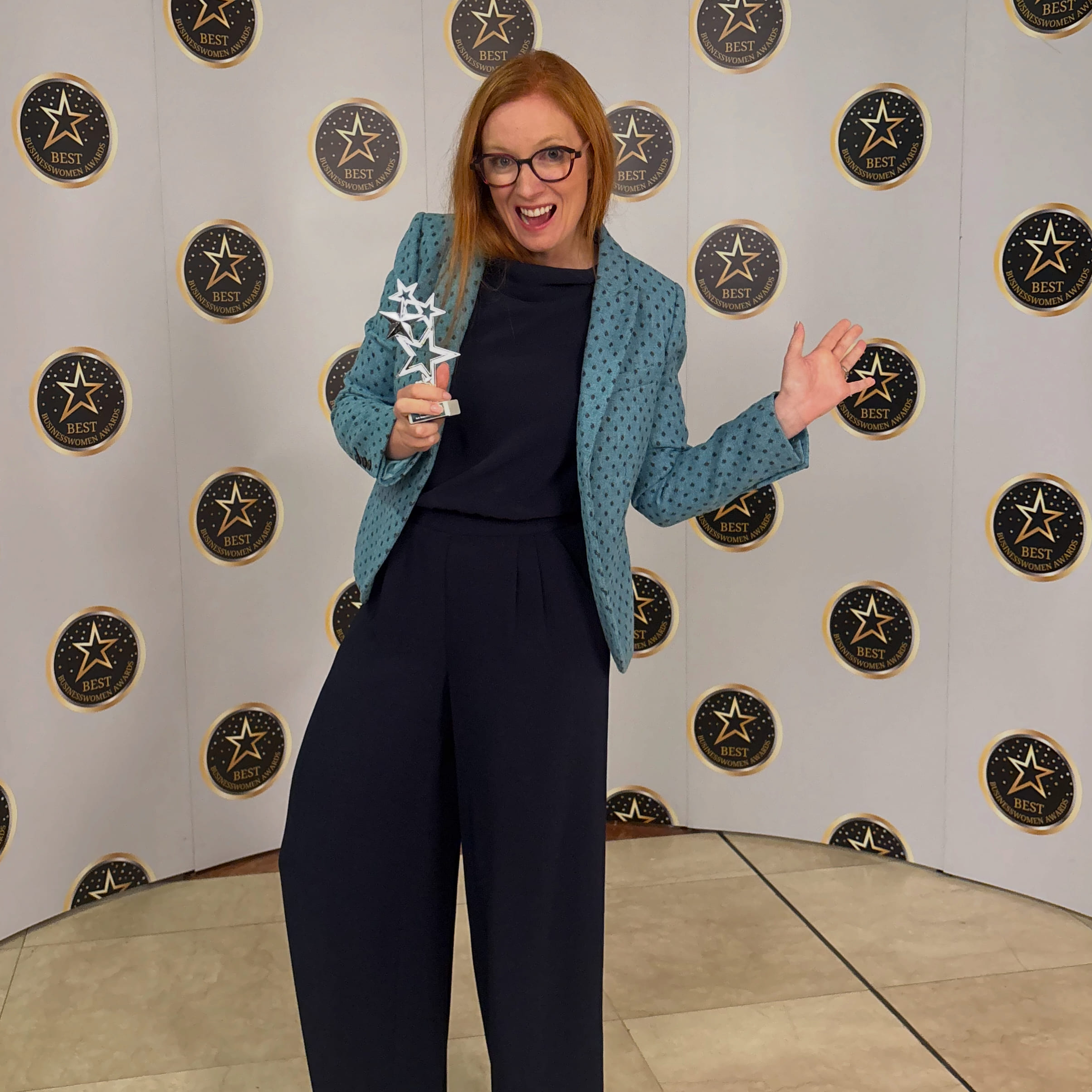 Laura Cross holding up her Best Business Women Award.