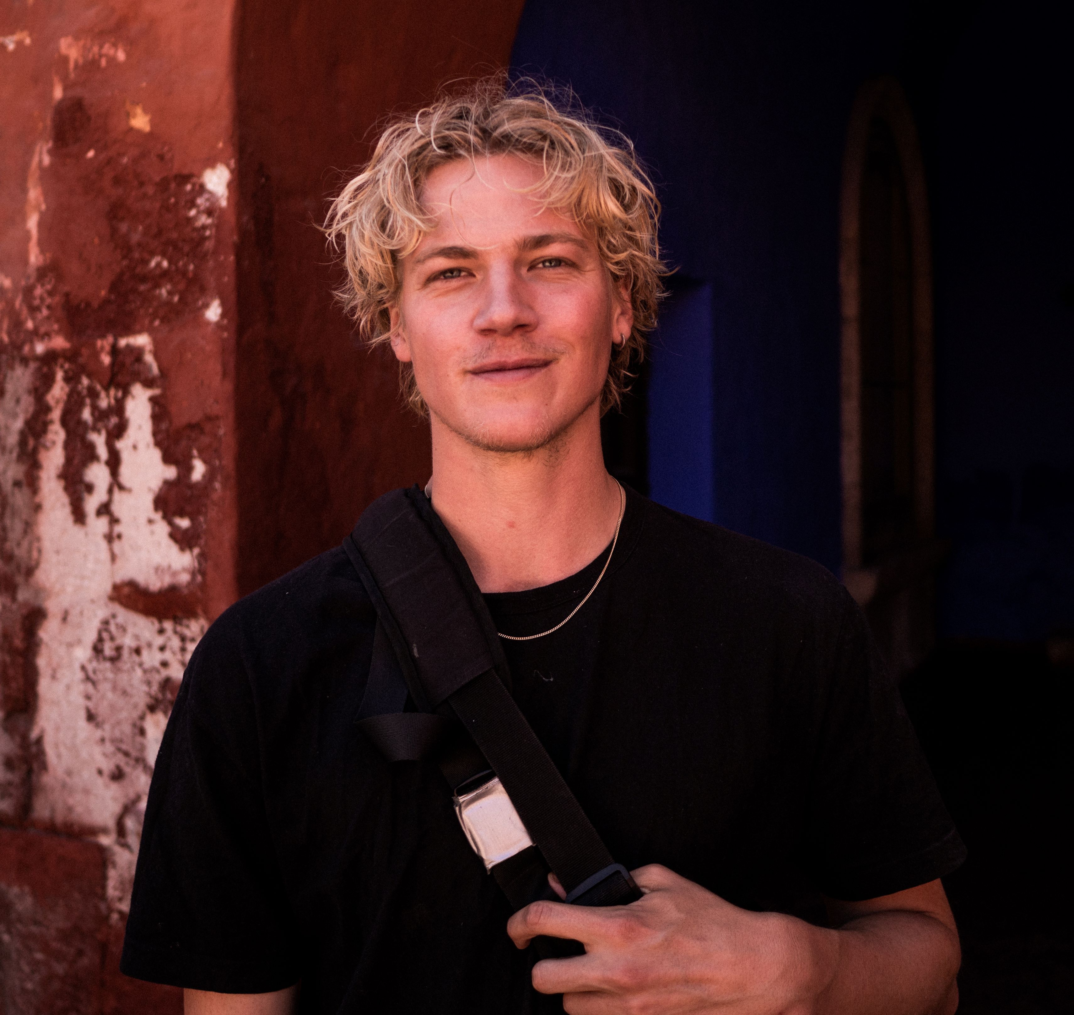 Photo of Magnus Eldrup smiling, wearing black t-shirt.