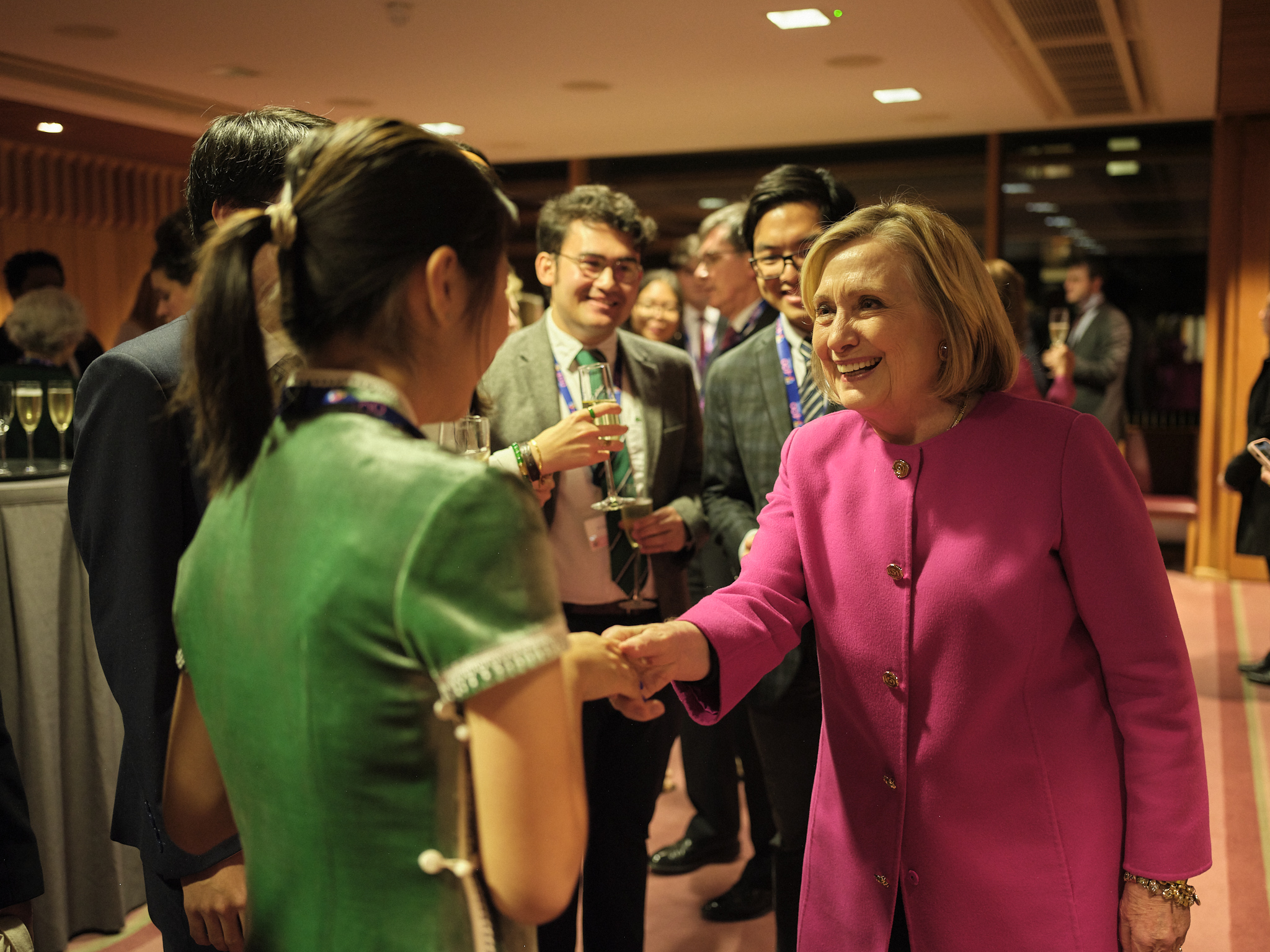 Secretary Hillary Rodham Clinton shaking hands with a student.