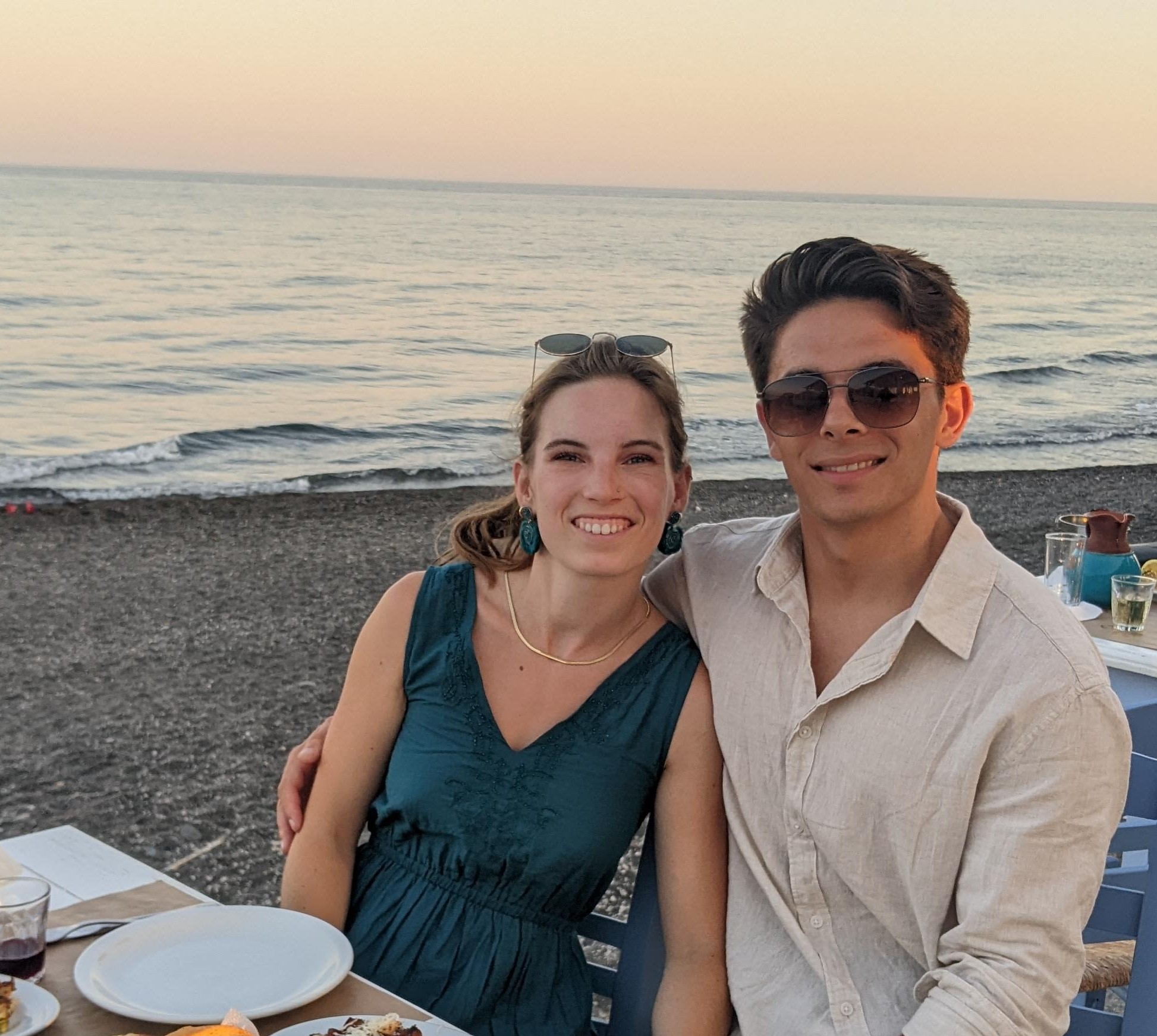 Ruth Arnold (left) and her husband Nathan (right), photographed on a beach at sunset.