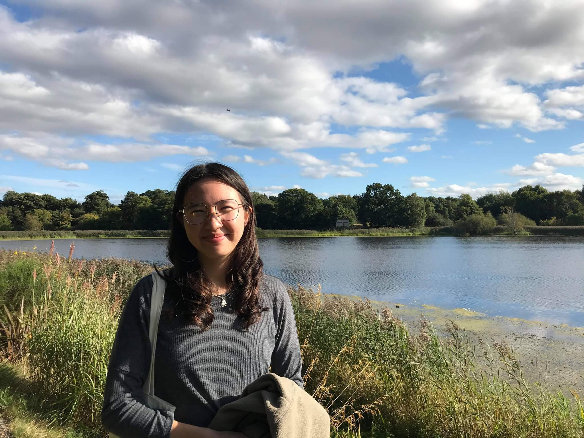 Photo of Vanessa smiling with a lake in the background