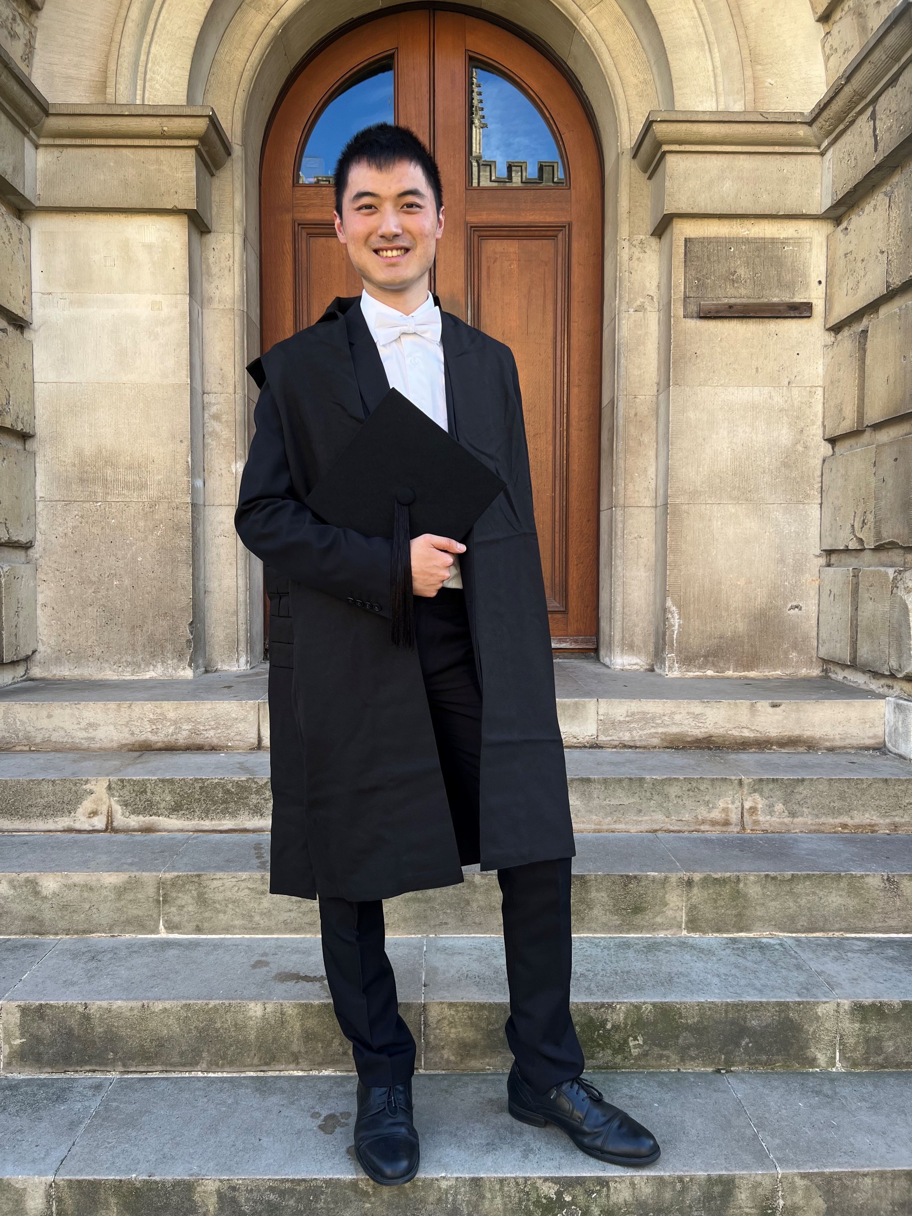 Dane Luo in sub fusc smiling.