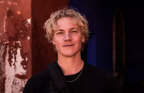 Photo of Magnus Eldrup smiling, wearing black t-shirt.