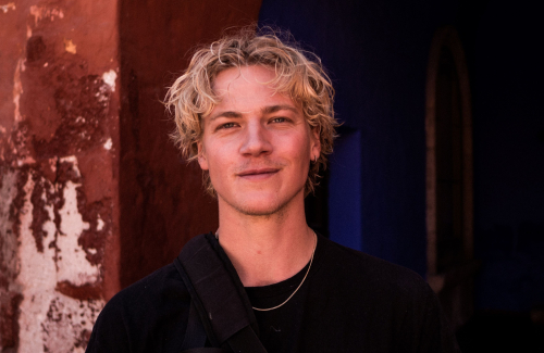 Photo of Magnus Eldrup smiling, wearing black t-shirt.