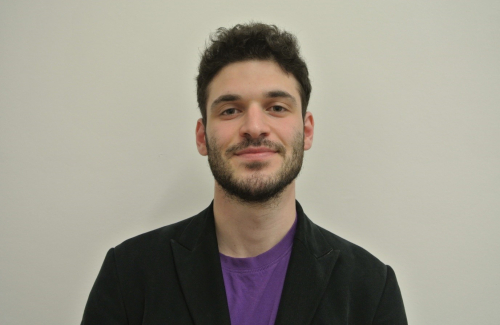 A headshot of Julius Kochan in front of a plain grey background.