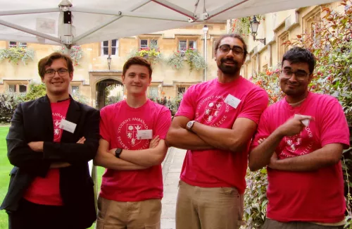 Four Pembroke students smiling with folded arms. 